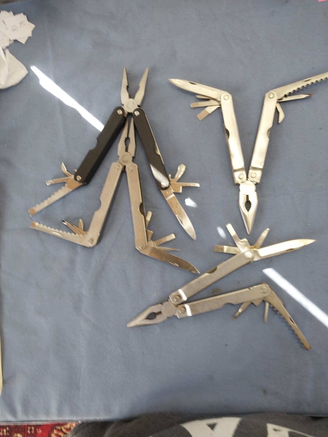 4 multi tools pliers screwdriver knife saw
