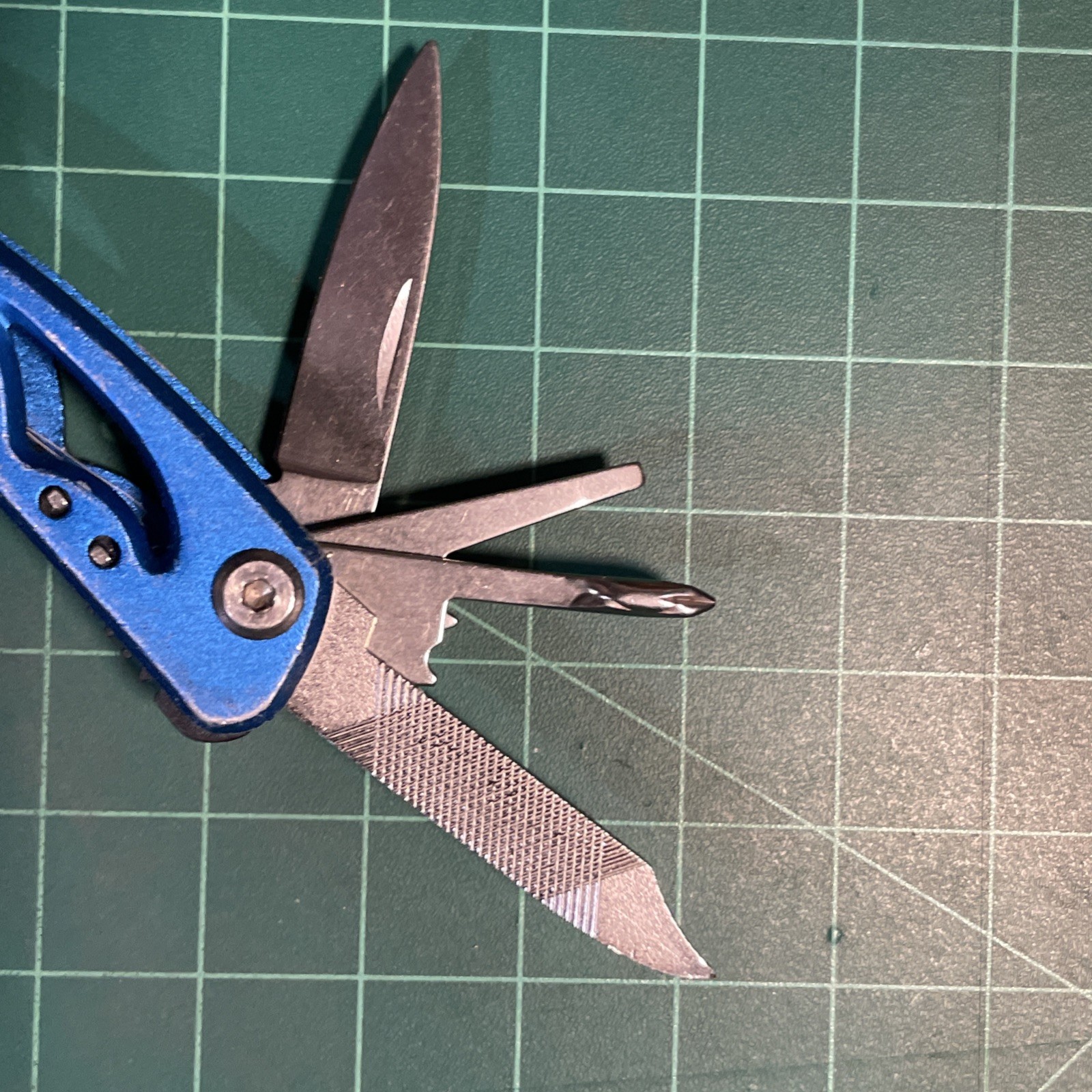 Blue Mini Multi Tool = pliers, knife, wire cutter, screwdrivers, files, etc.