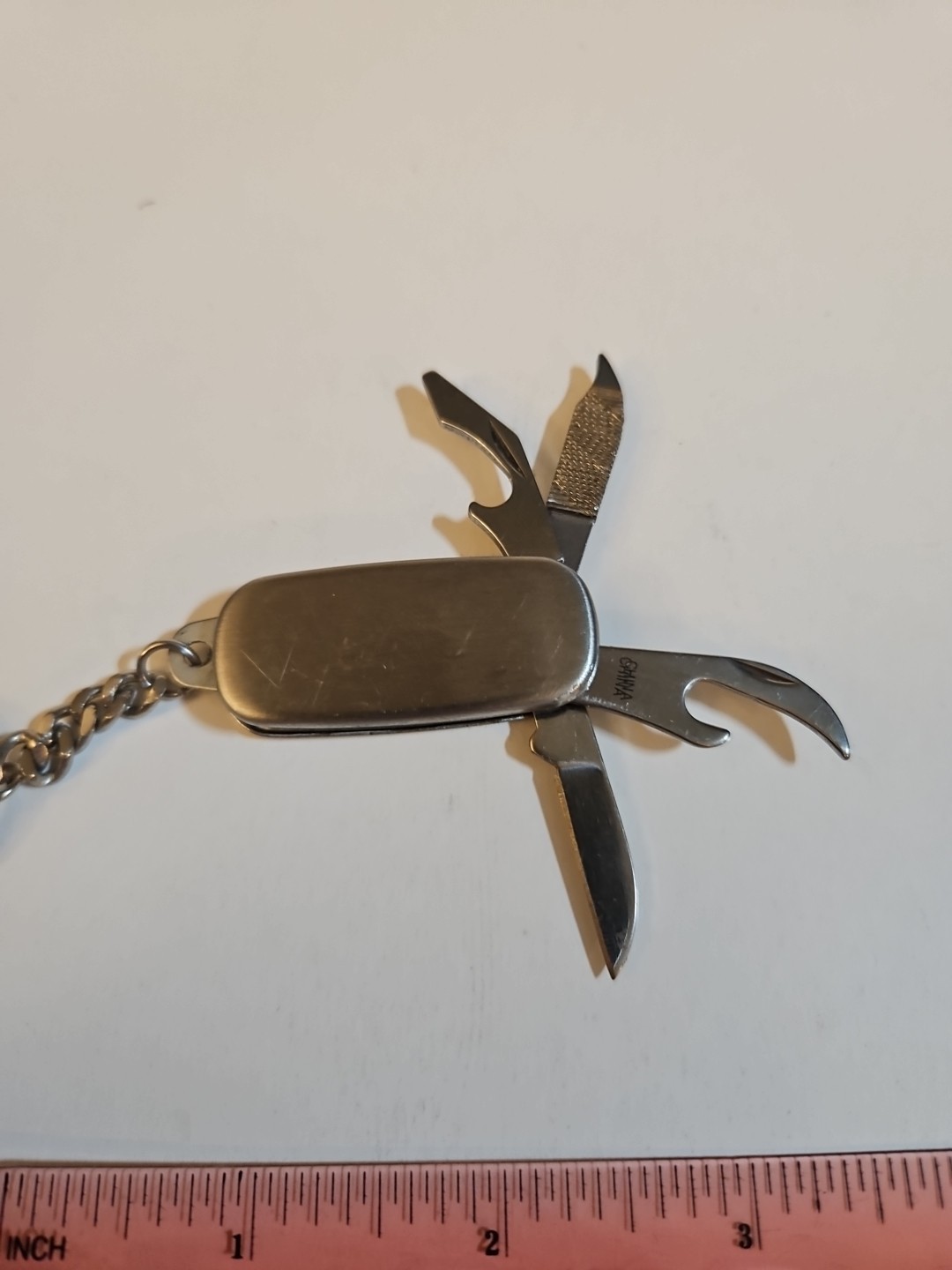 multi tool key chain stainless steel With P&G engineering On It.