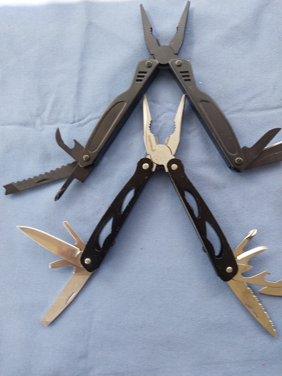 4 multi tools with pliers knives screwdrivers saw