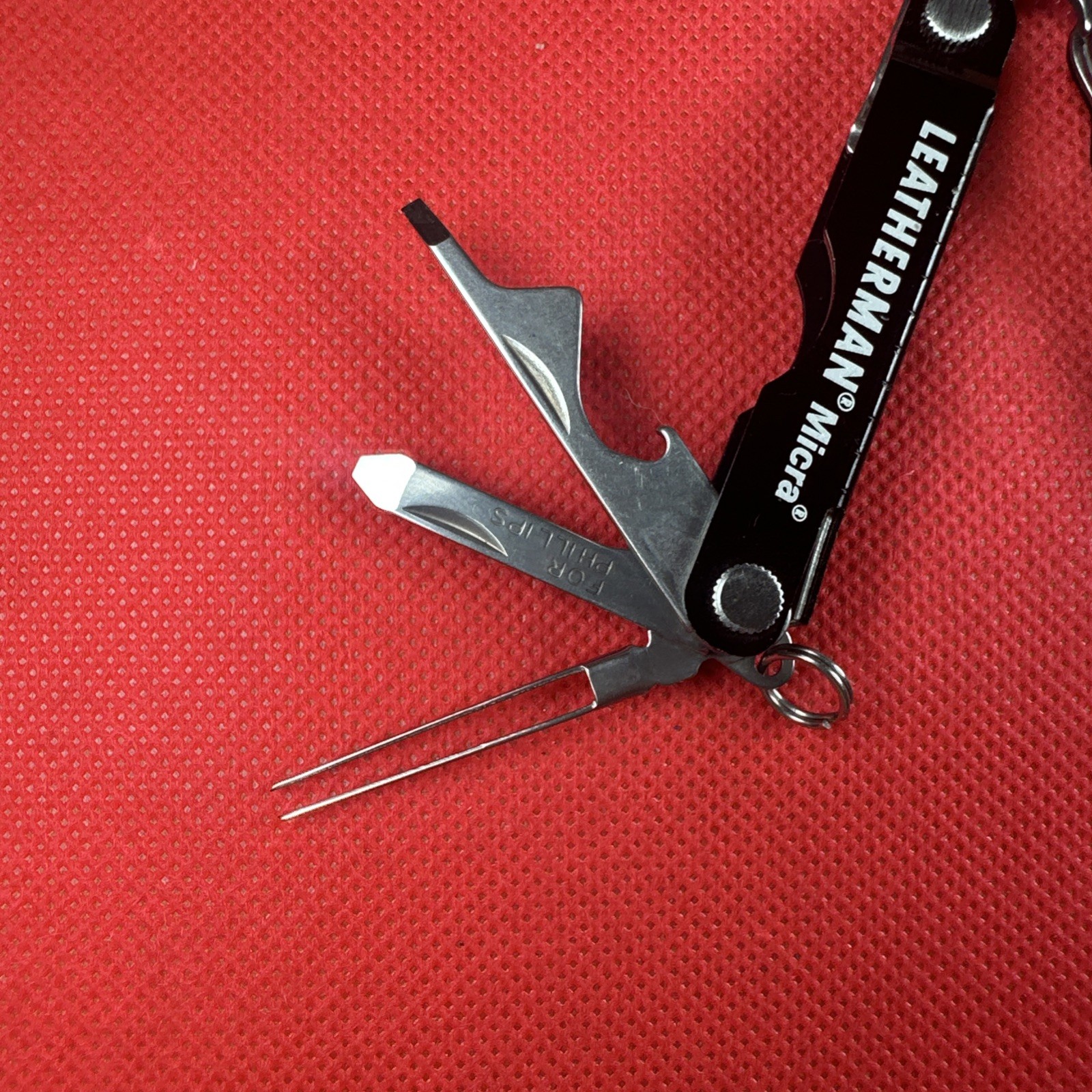 Nice Black Leatherman Micra Multi-Tool, scissor, knife, tweezer, screwdriver