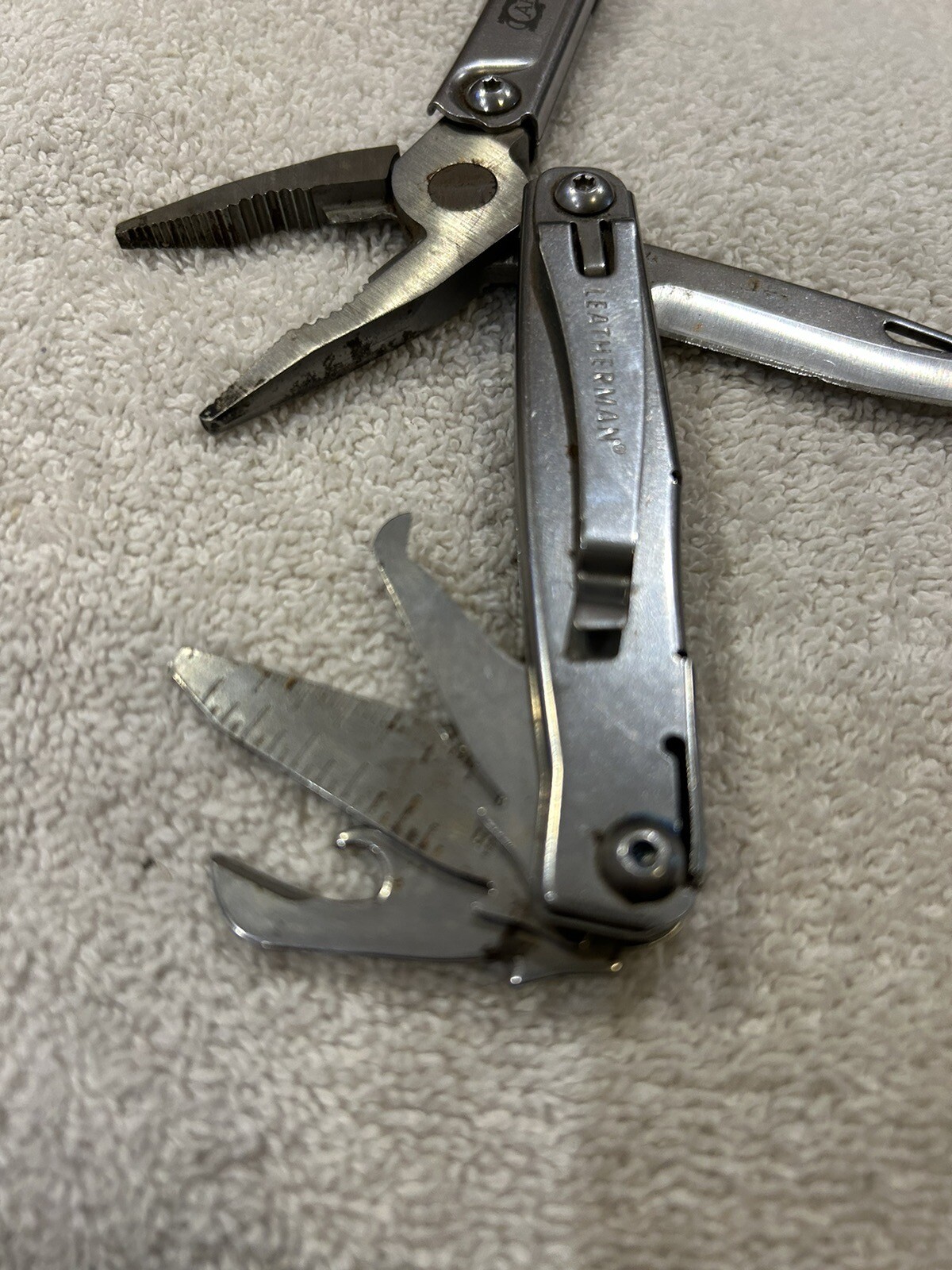 Leatherman Rev multitool with company logo