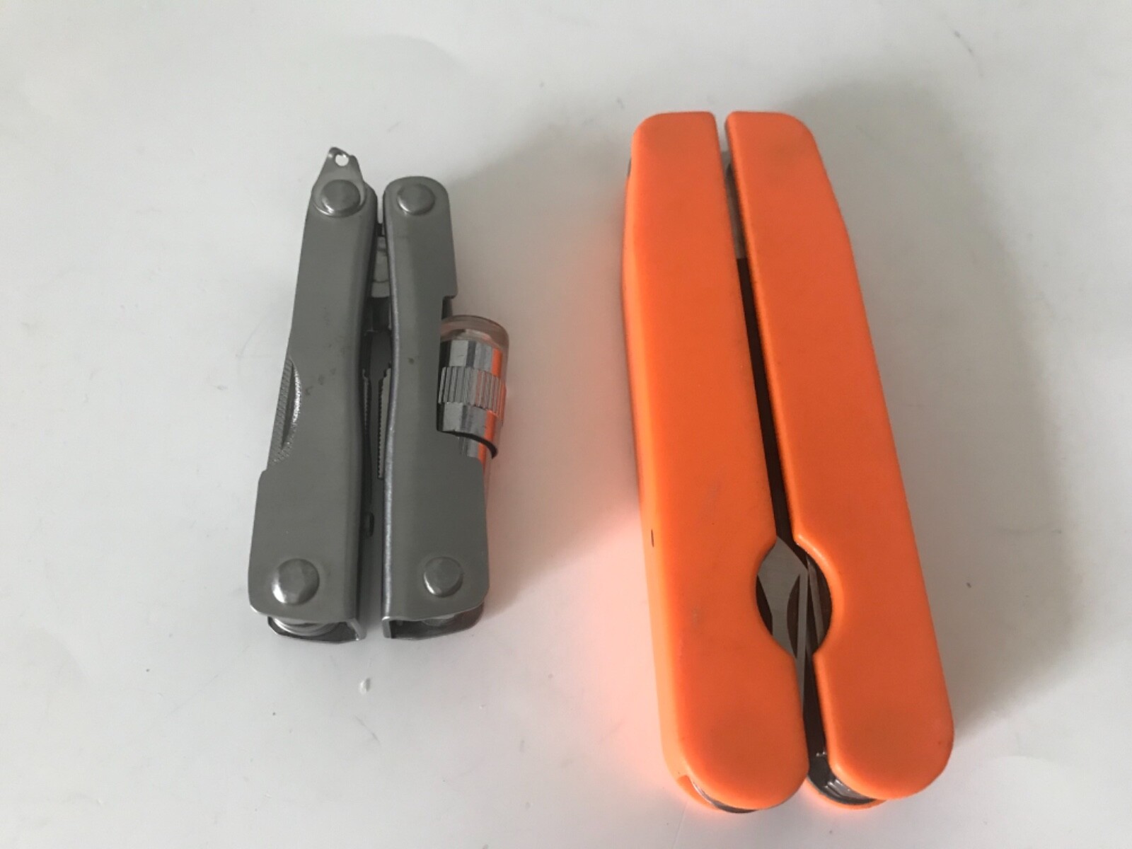 2 each leatherman style multi tools