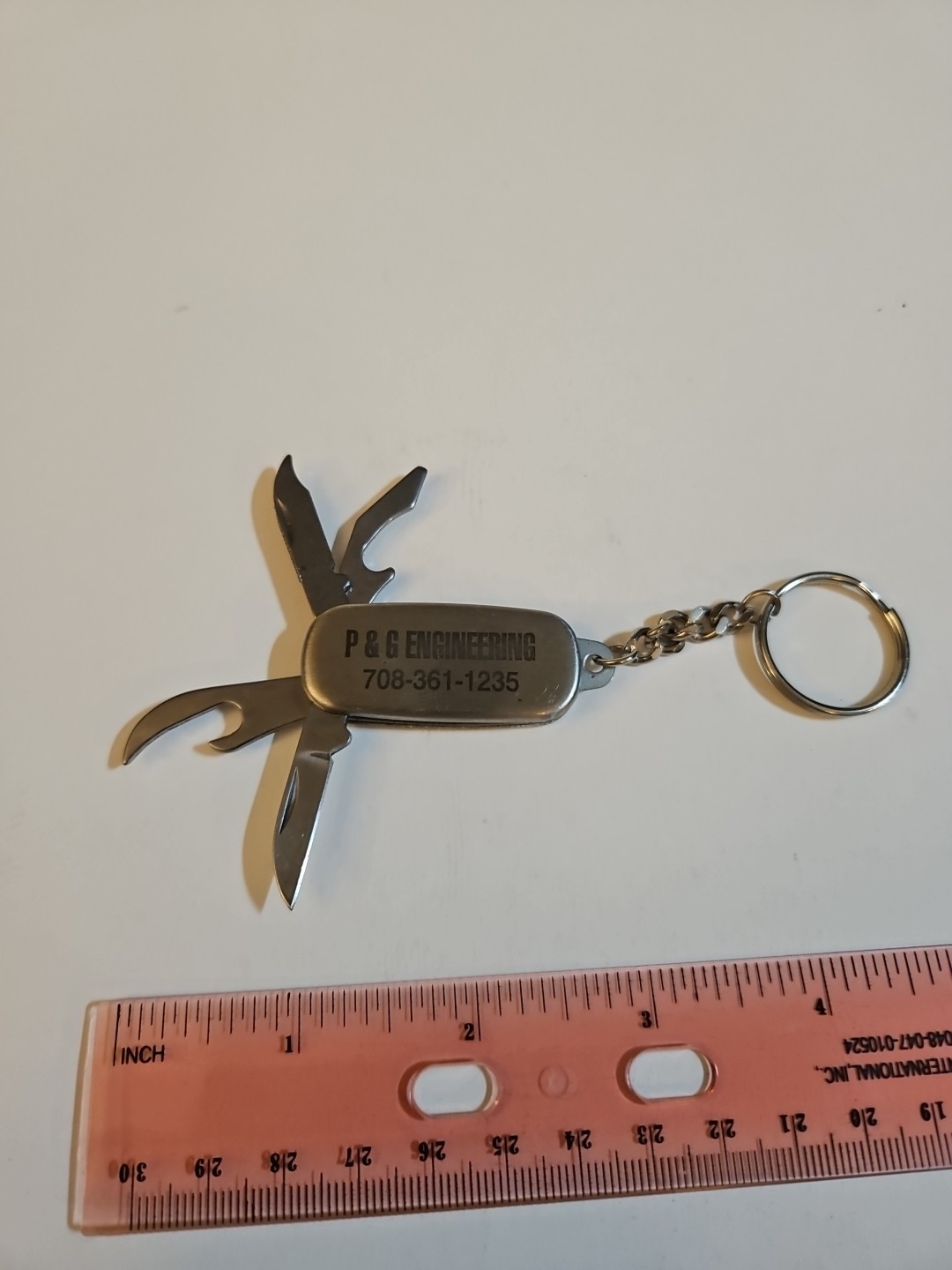 multi tool key chain stainless steel With P&G engineering On It.