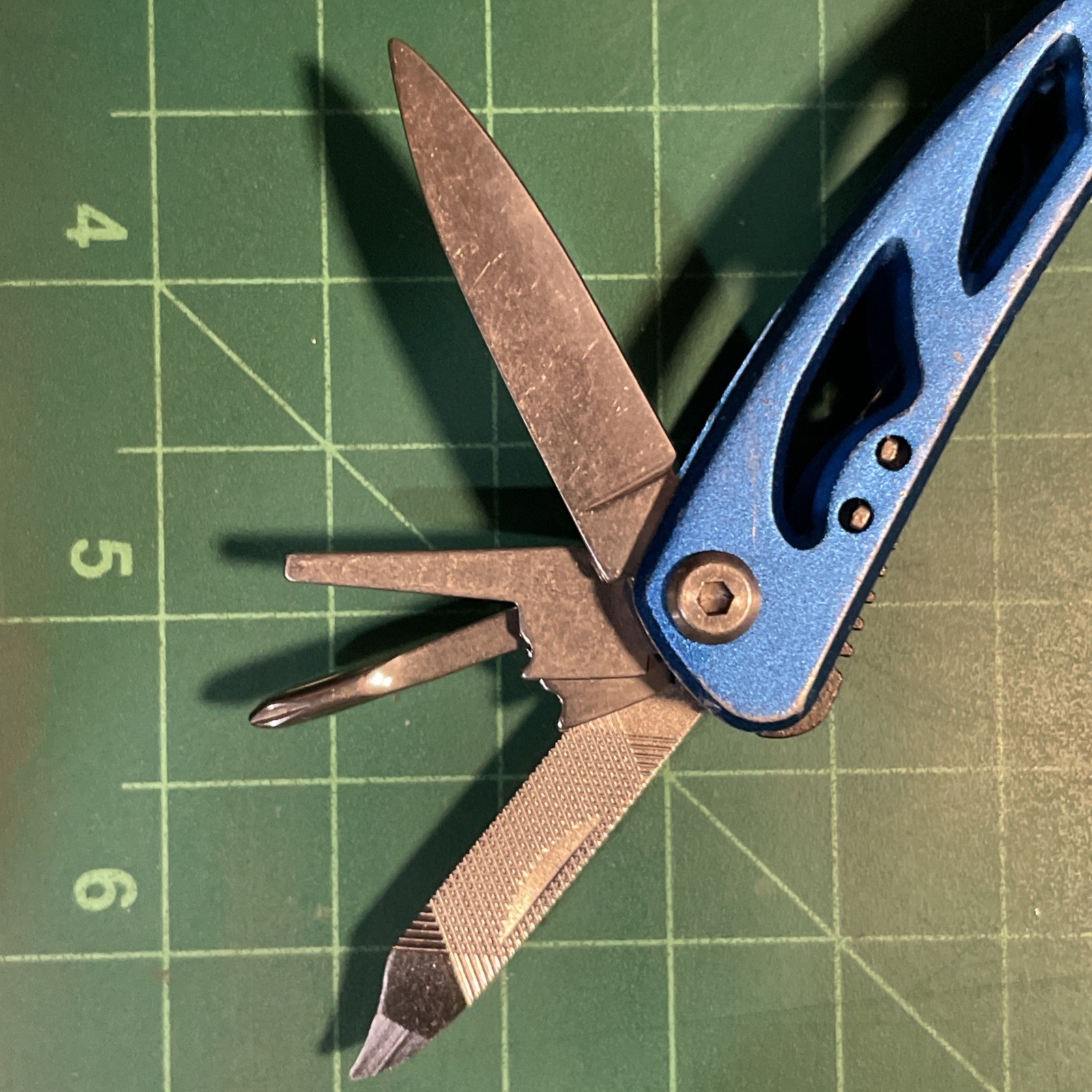 Blue Mini Multi Tool = pliers, knife, wire cutter, screwdrivers, files, etc.