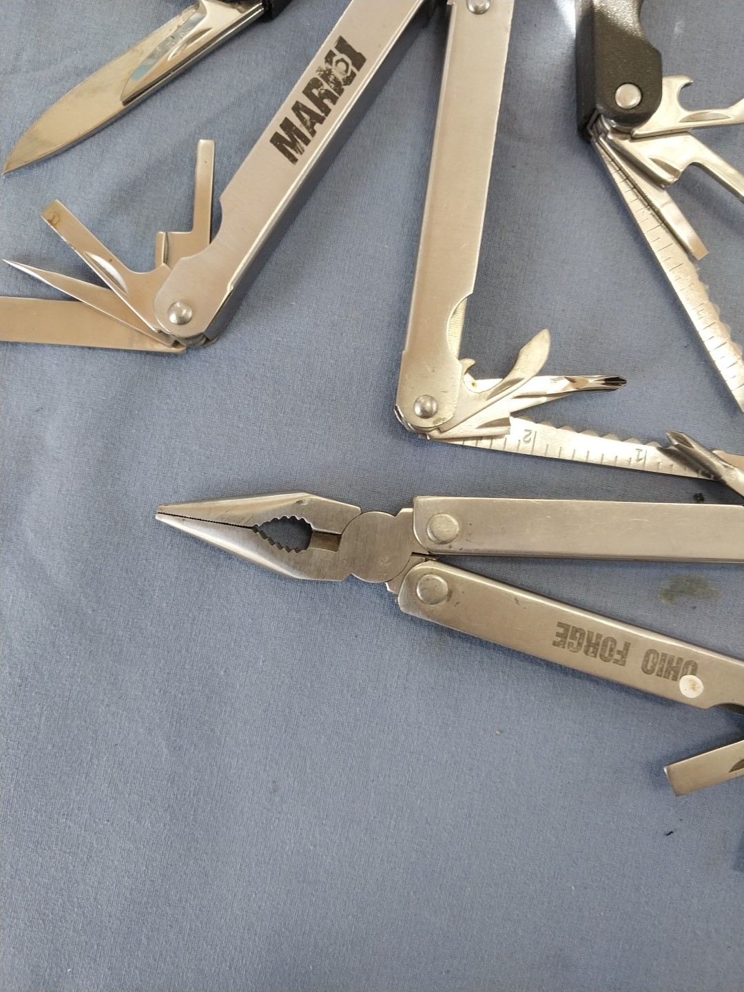 4 multi tools pliers screwdriver knife saw