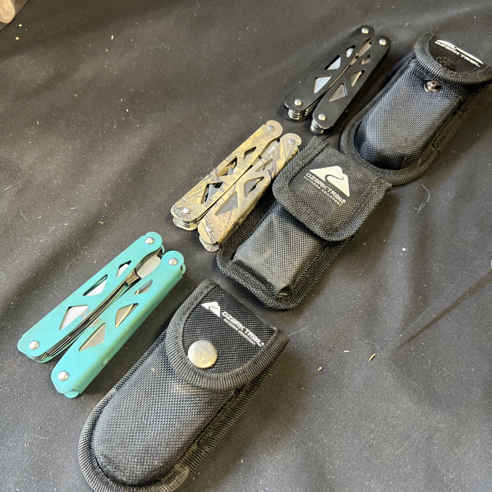 Set Of 3 Ozark Trail Trailside 12-in-1 Multitool – Black, Teal, & Camouflage