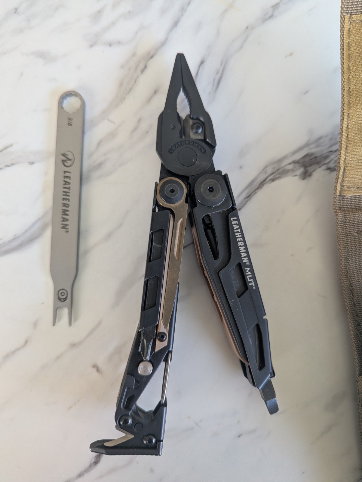 Leatherman MUT Black multi tool with Brown/Tan Inserts. Very good condition.