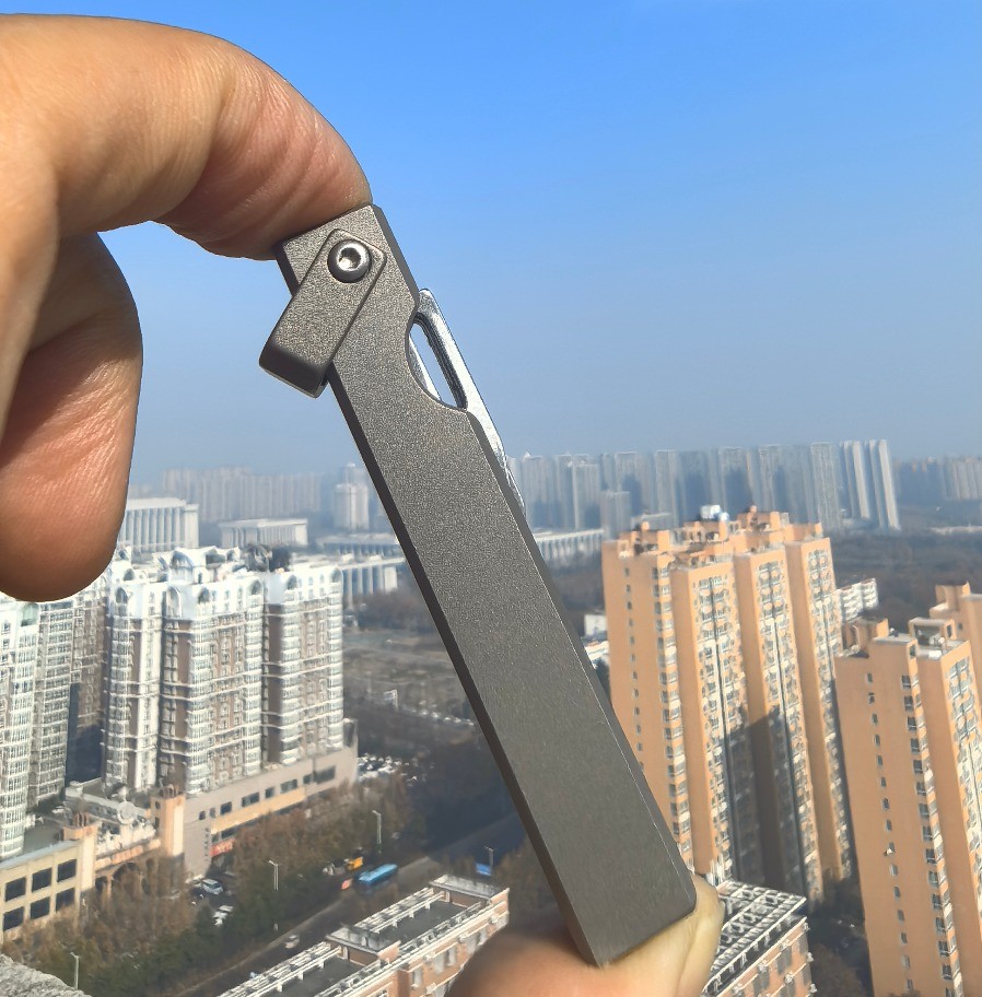 4-in-1 Compact Titanium Survival Tool Keychain with Saw Whistle and Pry Bar