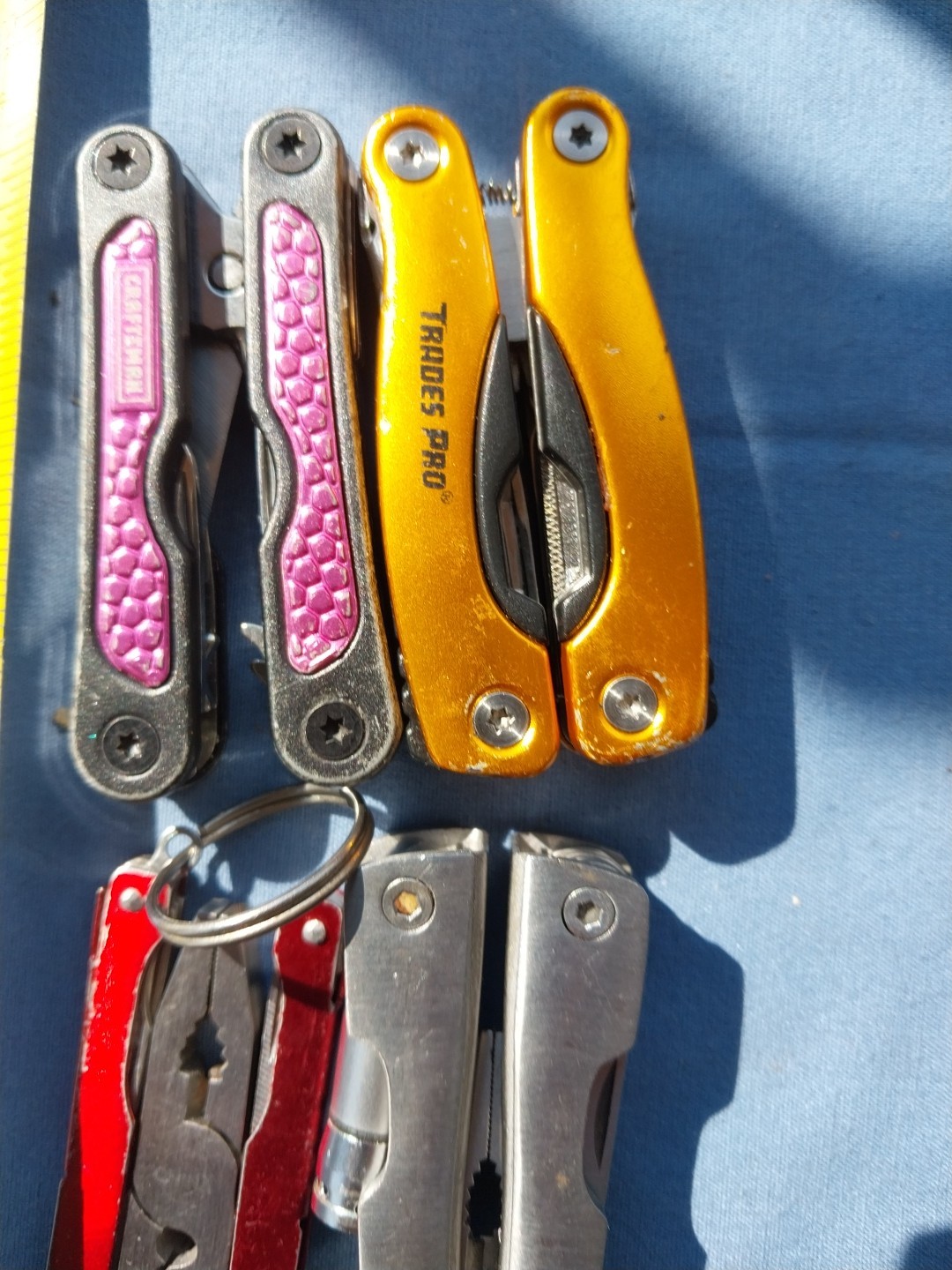 4 multi tools with pliers knives screwdrivers saw