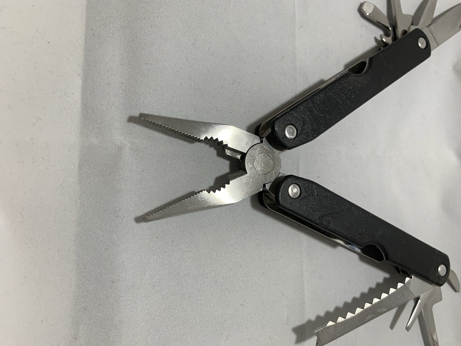 Barlow SuperPliers multi-tool featuring black handles with a “GULFEX” label