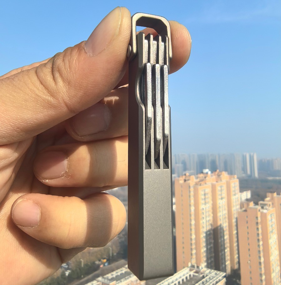 4-in-1 Compact Titanium Survival Tool Keychain with Saw Whistle and Pry Bar
