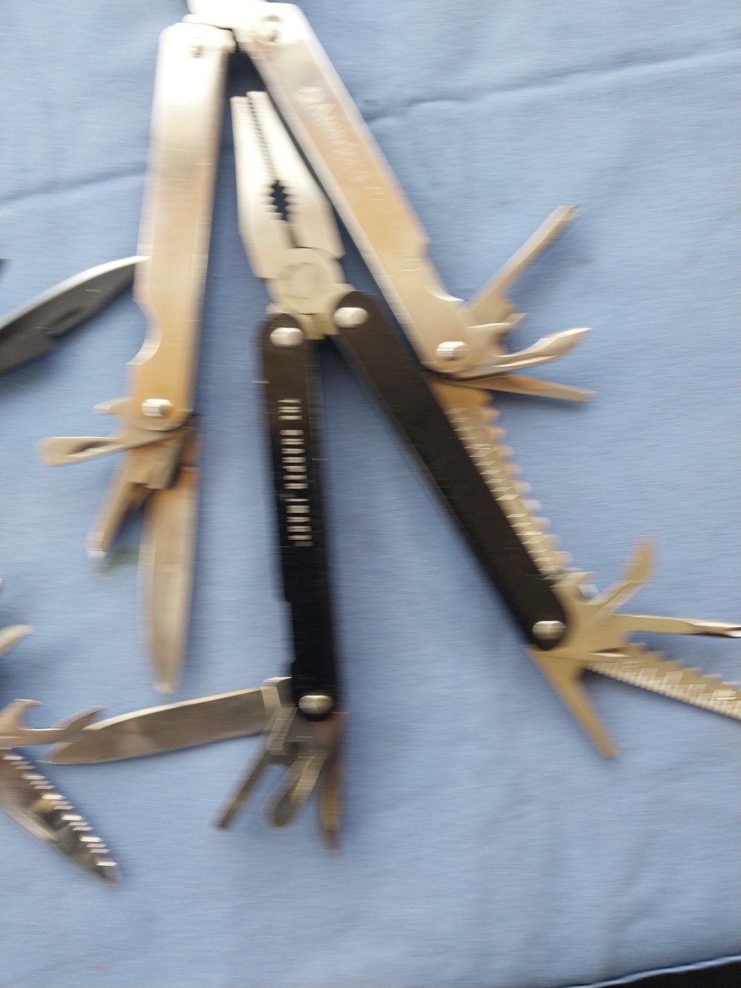 4 multi tools with pliers knives screwdrivers saw