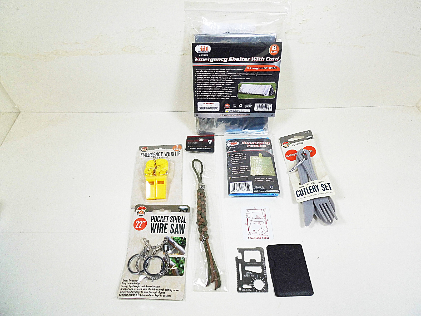 Survival Kit Outdoor Shelter Saw Multi-Tool Cutlery Poncho Whistle Cord Camping