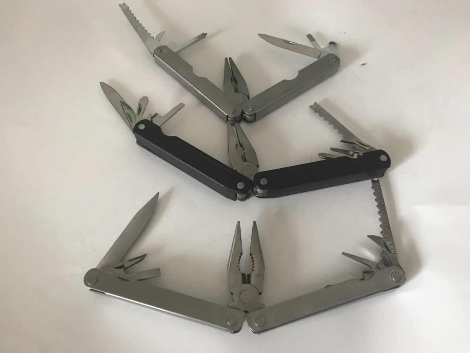 3 each leatherman style multi tools