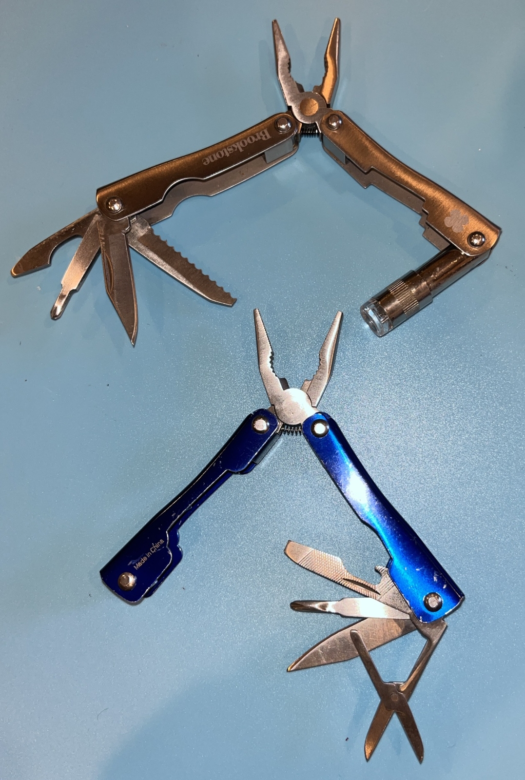 2 Brookstone Multi tool Knives, Flashlight Needs Battery