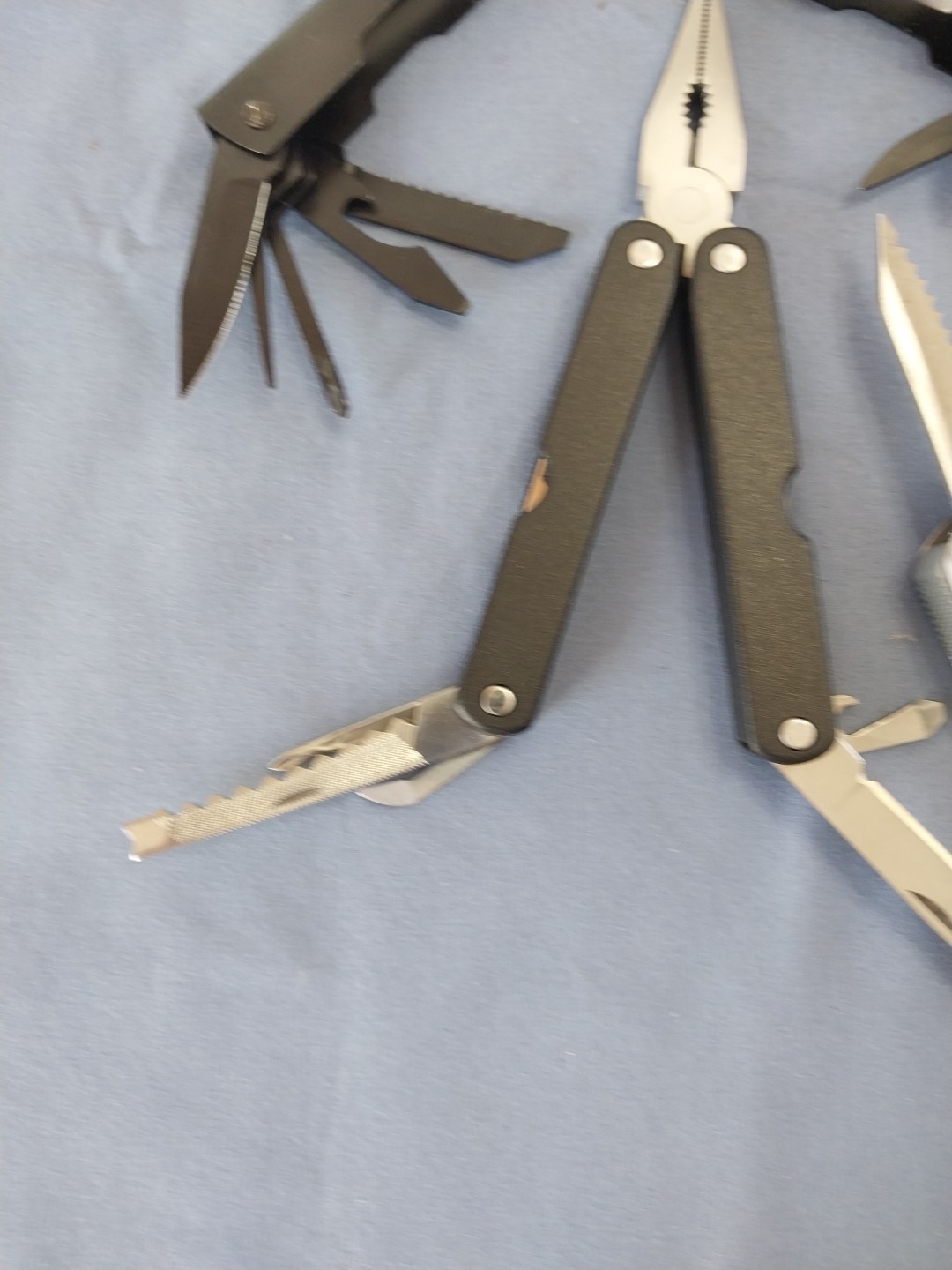 4 multi tools pliers screwdriver knife saw