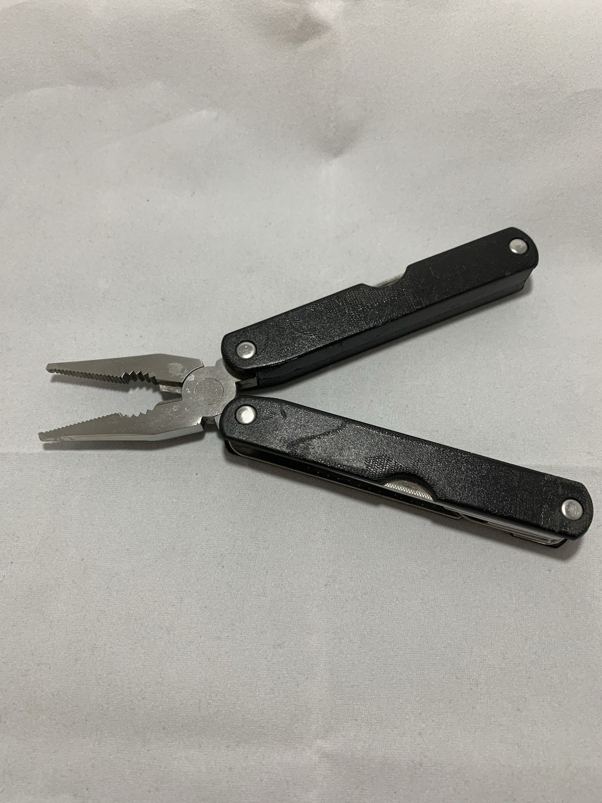 Barlow SuperPliers multi-tool featuring black handles with a “GULFEX” label