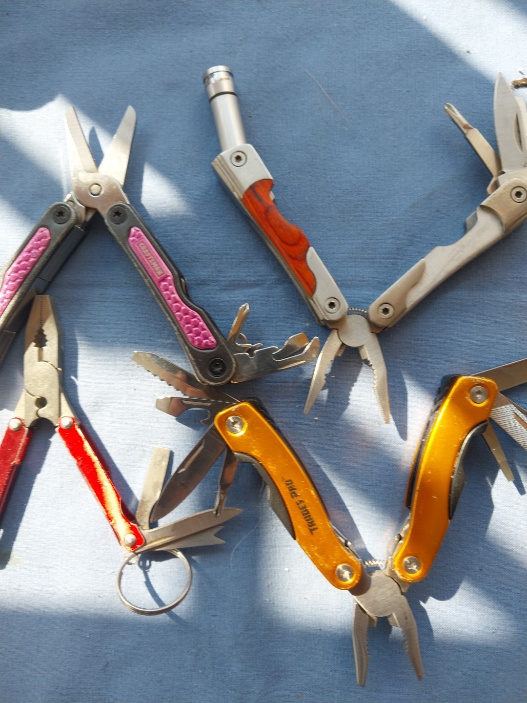 4 multi tools with pliers knives screwdrivers saw