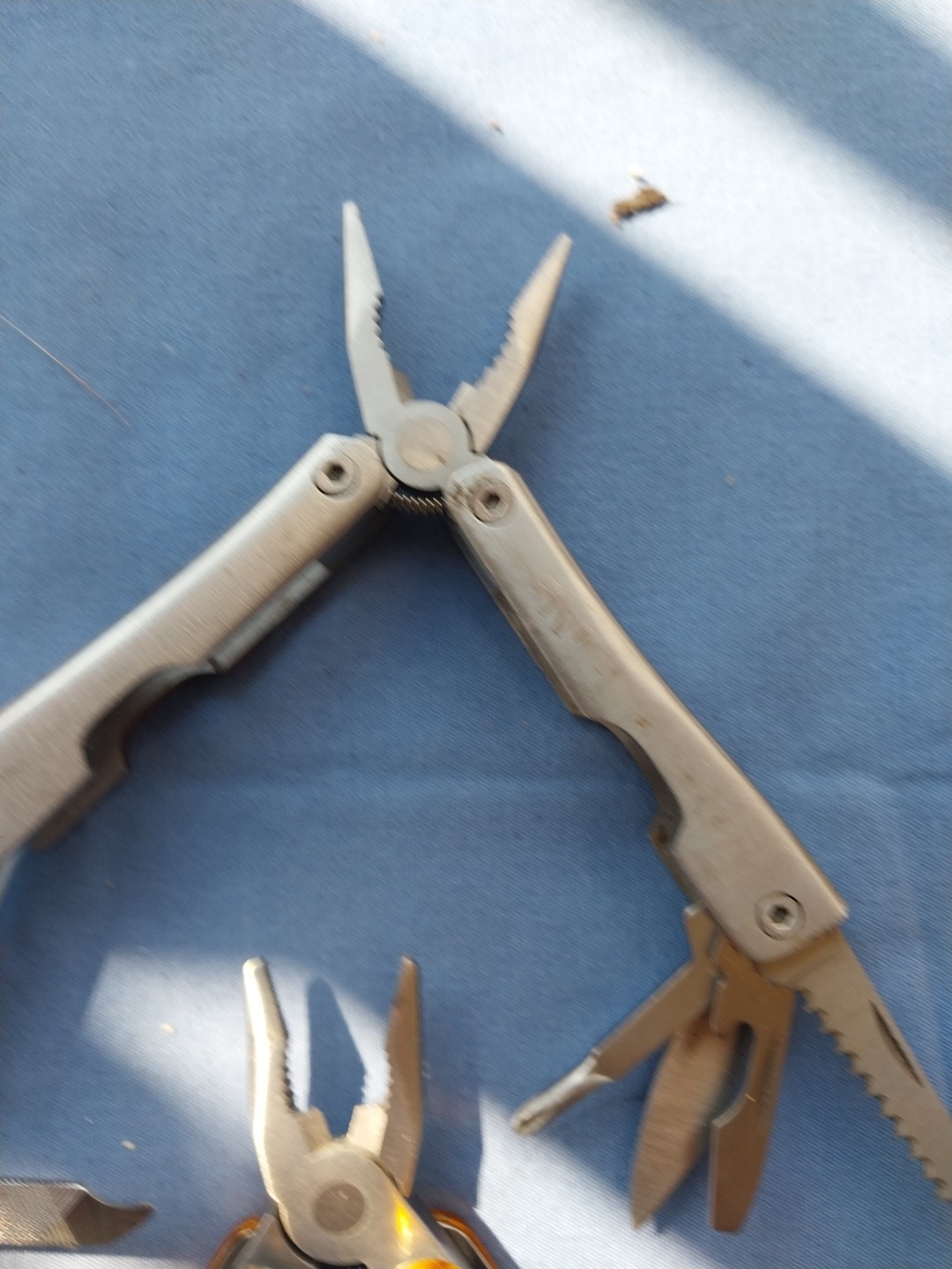4 multi tools with pliers knives screwdrivers saw