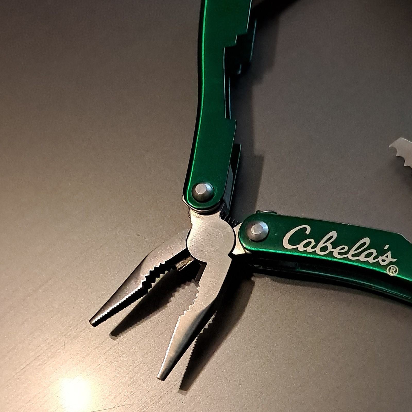 Cabela’s Green/Silver 6-in-1 Multi-Tool Pliers, 2.25″ SS Blade w/ Sheath