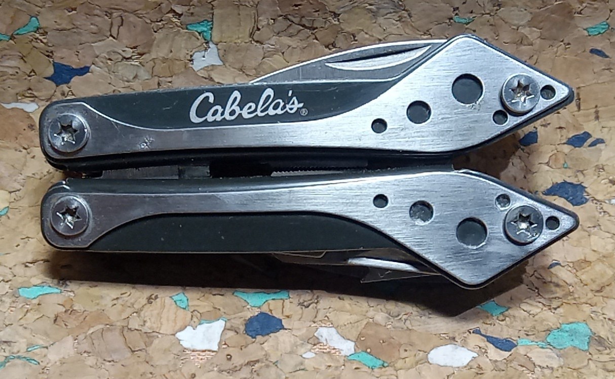 USED SILVER CABELA’S 7 IN 1 MULTI-TOOL VERY GOOD CONDITION