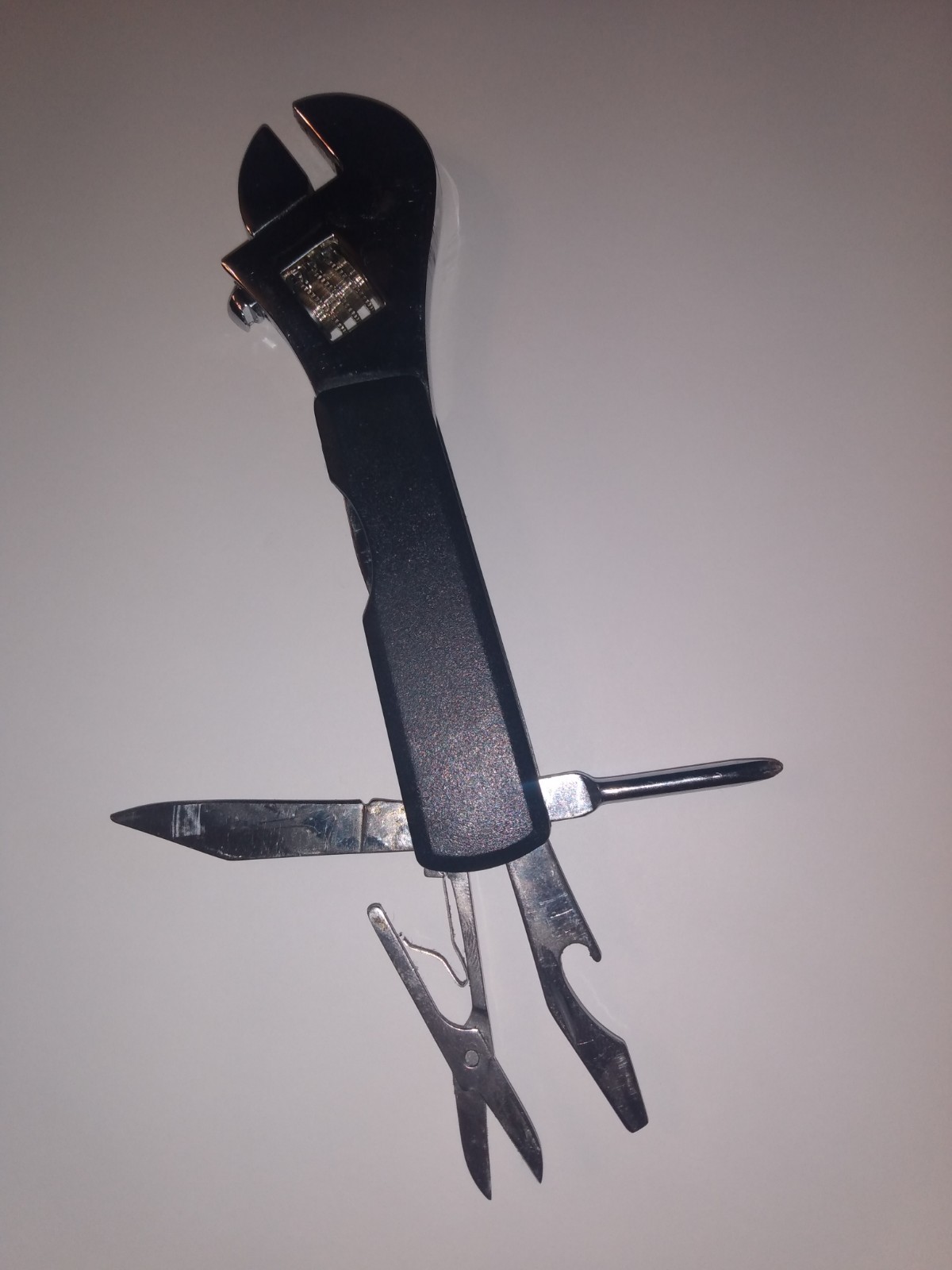 Multi tool adjustable wrench, knife, small screw drivers, cap opener