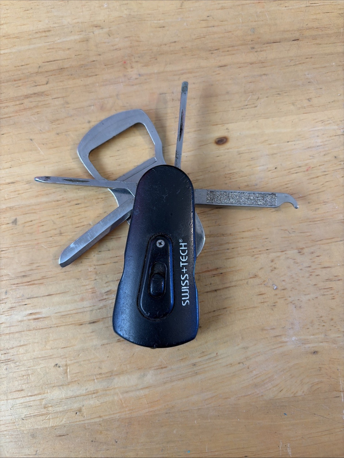 Swiss+Tech Swivel Tool 8-in-1 bottle opener multi tool with light