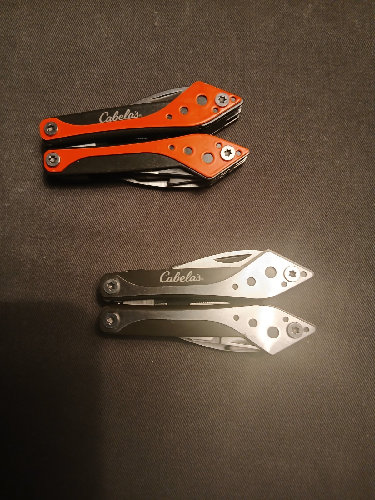 Lot 0f 2 Cabela’s Multi-Tool 1) Silver /1) Orange Unused with Cases