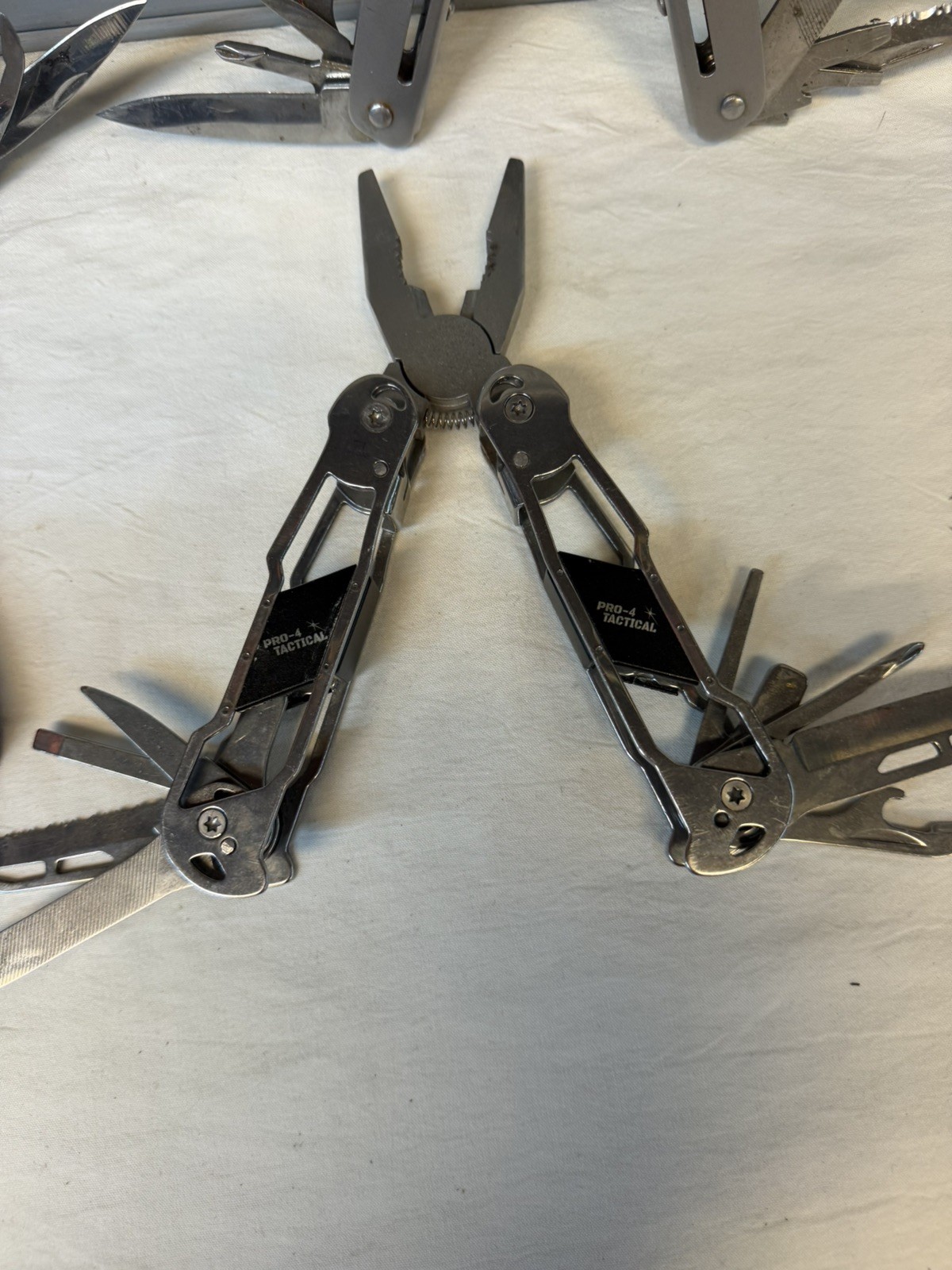 4 Multi-Tools / Pro-4 Tactical, Husky and 2 Unbranded / Good Variety of Tools