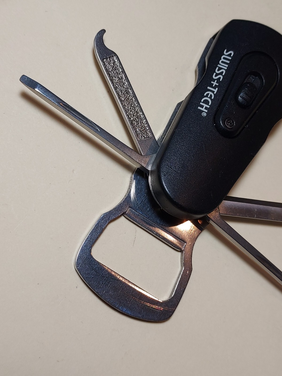 Swiss+Tech Swivel Tool 8-in-1 bottle opener multi tool with light