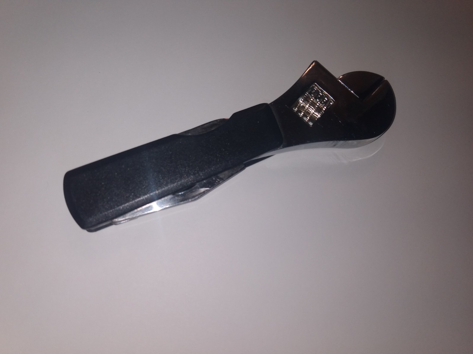 Multi tool adjustable wrench, knife, small screw drivers, cap opener
