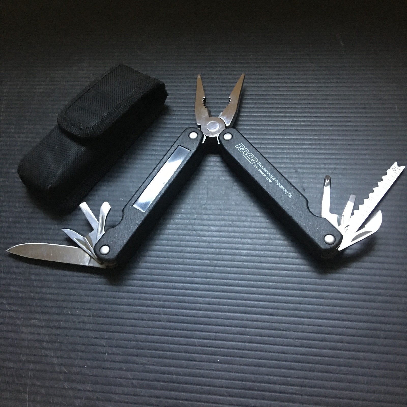 RACO 10-in-1 Multi-Tool with Pliers, Knife, Ruler & Saw in Black Nylon Sheath
