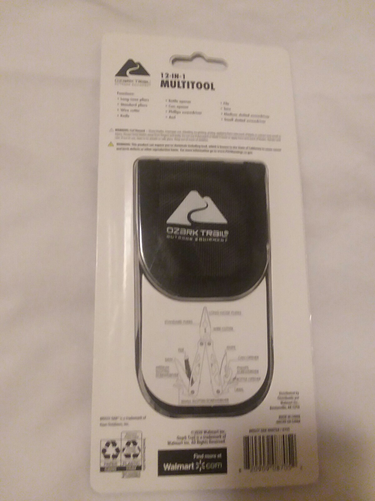 Ozark Trail 12-in-1 Multi Tool with Nylon Black Sheath. White camo handle.