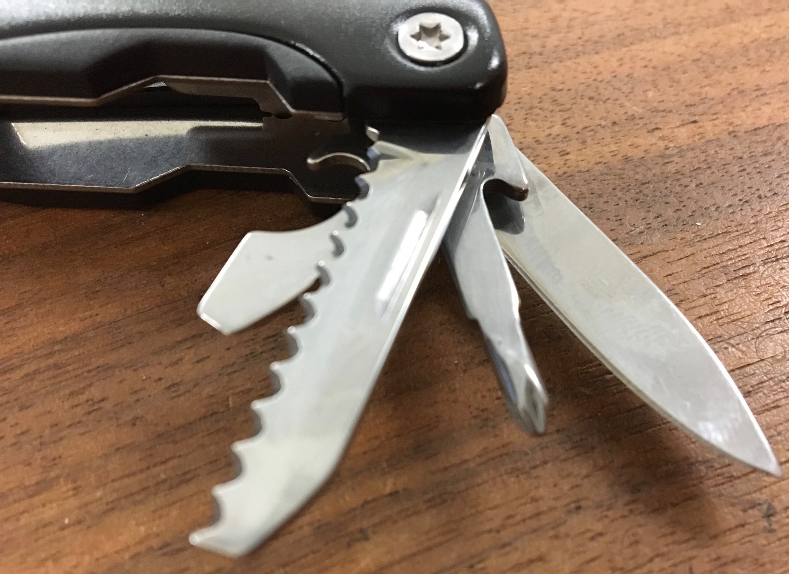 Pair of multi tools, one blue, the other black, with sheaths. Camp, hunt, crafts
